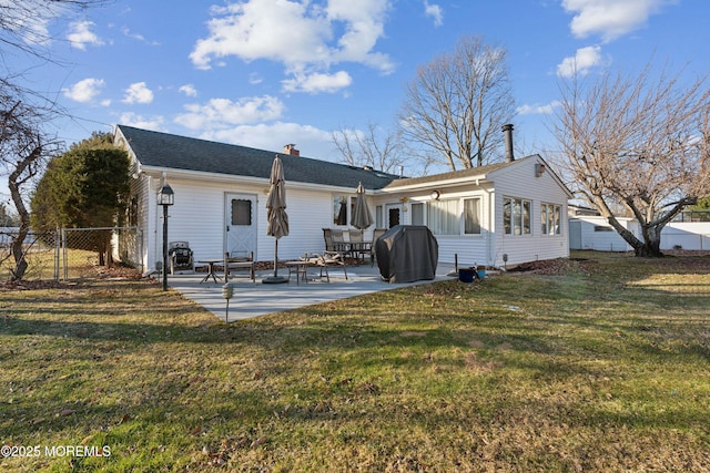 rear view of property with a lawn and a patio area