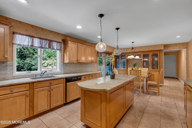 kitchen with sink, paneled dishwasher, hanging light fixtures, a kitchen island, and light tile patterned flooring