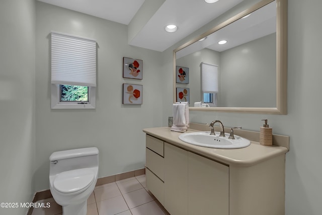 bathroom featuring vanity, tile patterned floors, and toilet