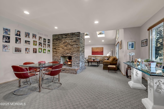 carpeted dining space featuring a brick fireplace