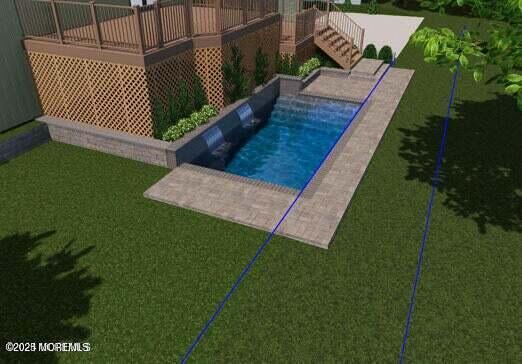 view of pool featuring a wooden deck and a yard