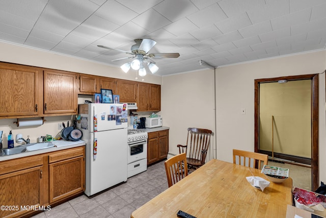 kitchen with extractor fan, sink, white appliances, ornamental molding, and ceiling fan