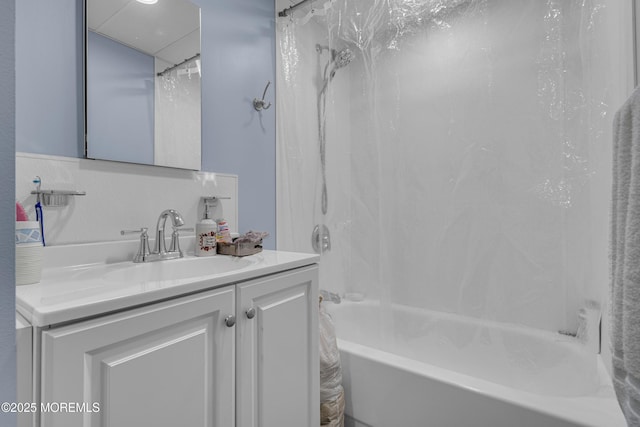 bathroom featuring vanity and shower / bath combination with curtain