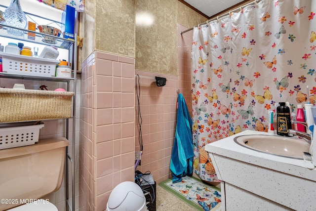 bathroom with vanity, tile walls, curtained shower, and toilet