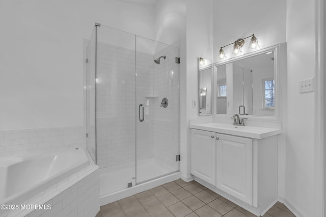 bathroom featuring plus walk in shower, tile patterned floors, and vanity