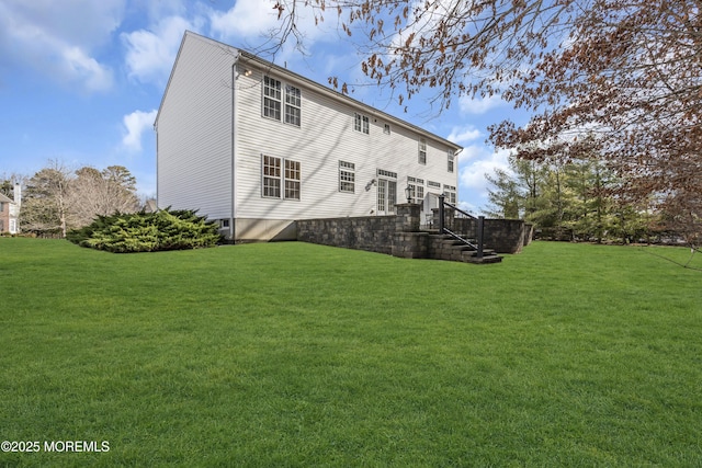 rear view of property featuring a yard