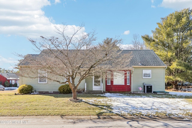 view of front of house with central AC unit and a front yard