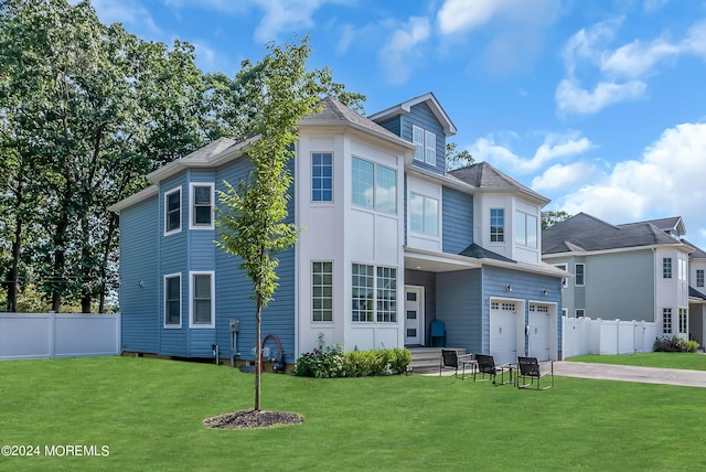 view of front of property featuring a garage and a front yard