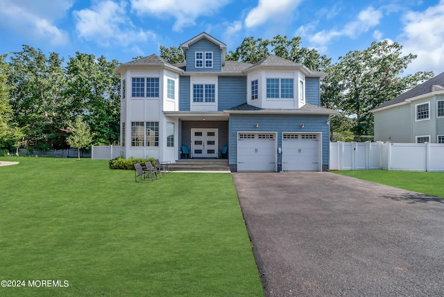 view of front of property with a garage and a front yard