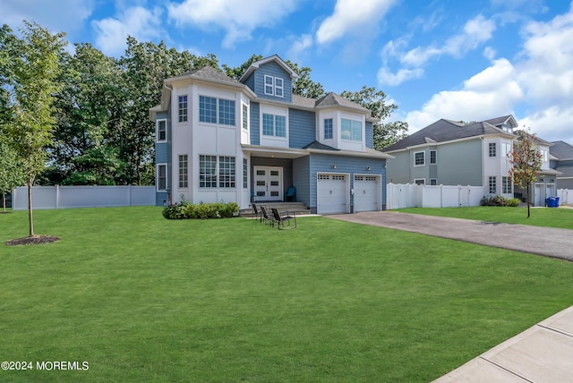 view of front property with a garage and a front yard