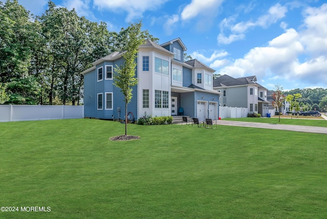 view of front of house featuring a garage and a front yard