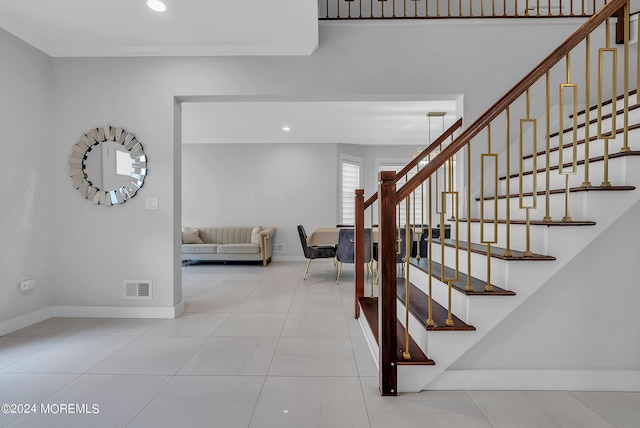 stairway featuring tile patterned flooring