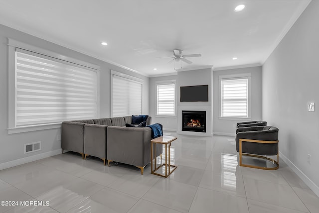 tiled living room with crown molding and ceiling fan