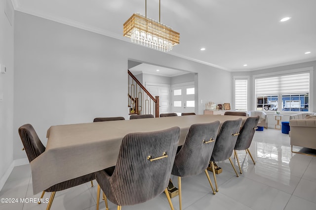 dining room featuring light tile patterned floors, crown molding, and french doors