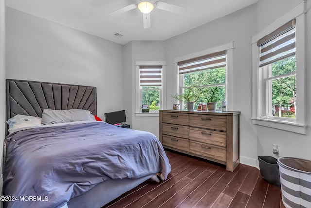 bedroom with dark hardwood / wood-style flooring and ceiling fan