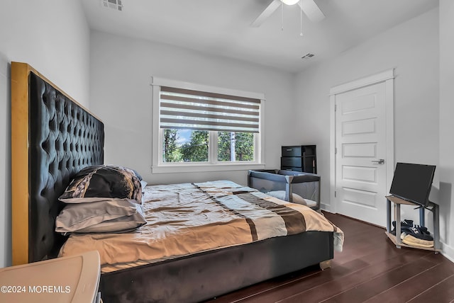 bedroom with ceiling fan and dark hardwood / wood-style flooring