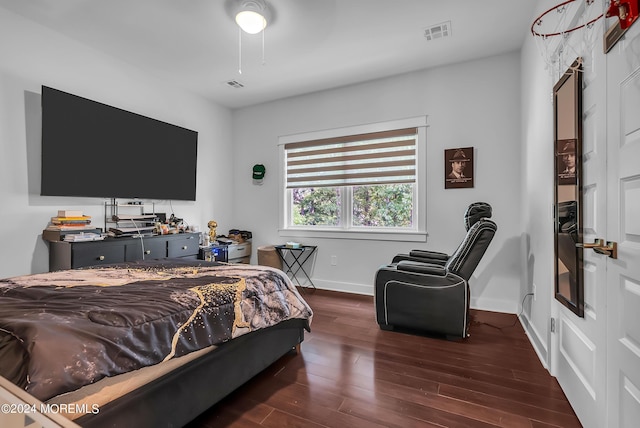 bedroom with dark wood-type flooring