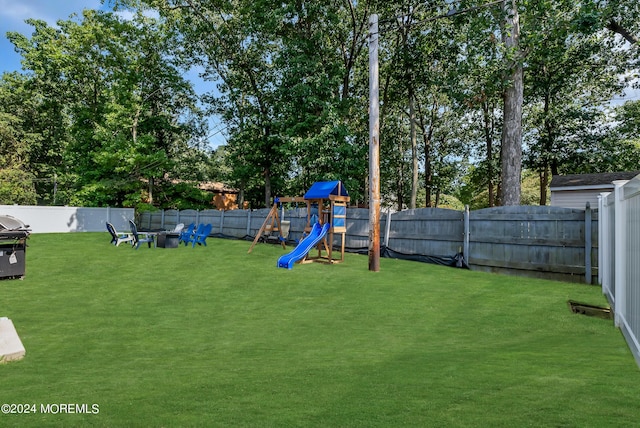 view of jungle gym featuring a lawn