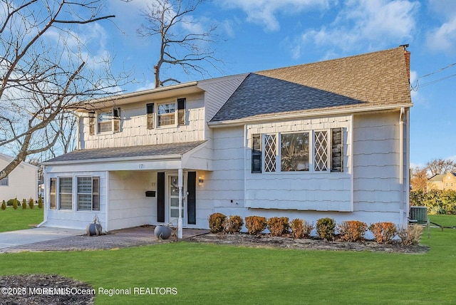 view of front of property featuring central AC unit and a front yard