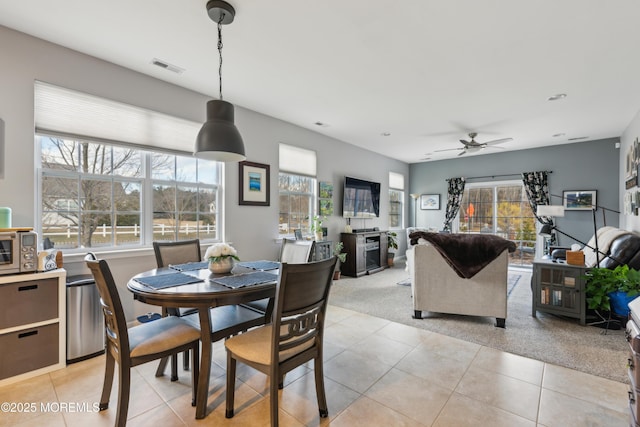 dining space featuring light tile patterned floors and ceiling fan