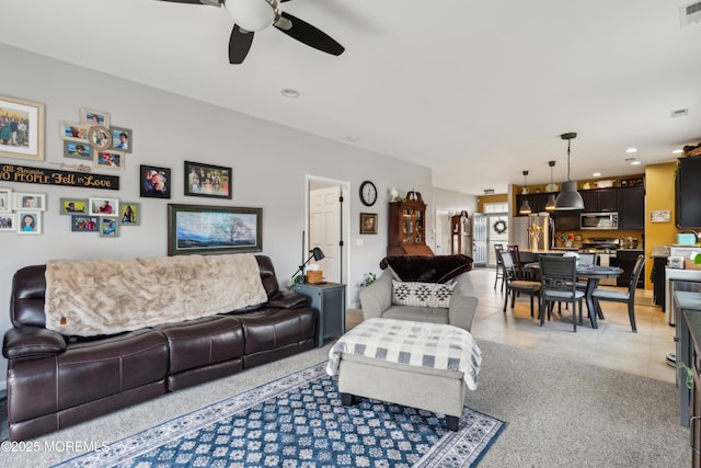 living room with light tile patterned flooring and ceiling fan