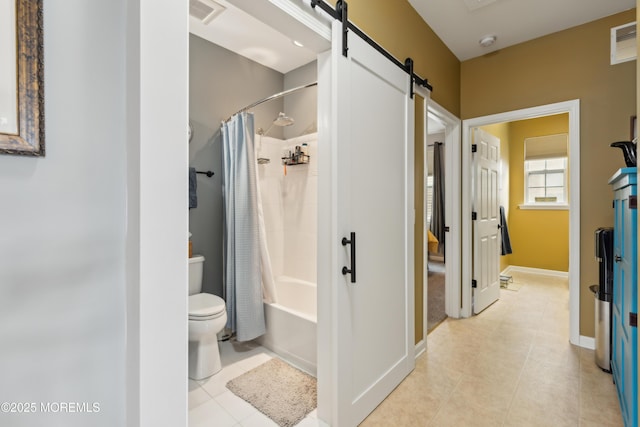 bathroom with tile patterned floors, toilet, and shower / bath combo with shower curtain