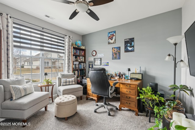 carpeted home office with ceiling fan