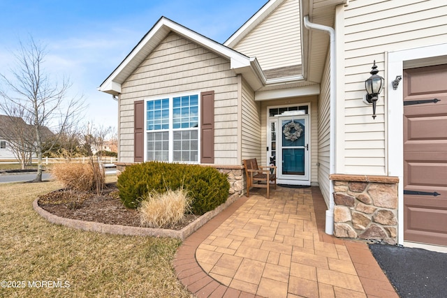 view of exterior entry with a garage