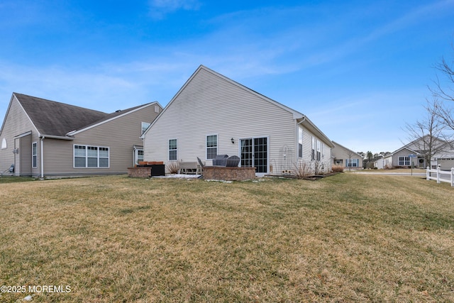 rear view of house with a yard