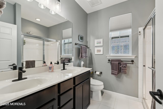 bathroom with vanity, tile patterned floors, a shower with door, and toilet