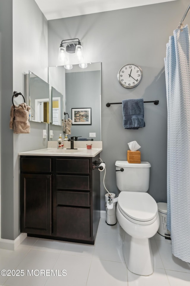 bathroom featuring vanity, curtained shower, tile patterned floors, and toilet