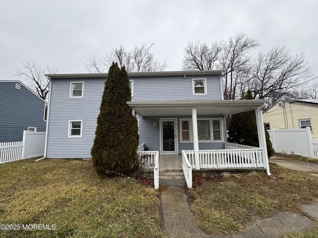 front of property featuring a porch and a front lawn