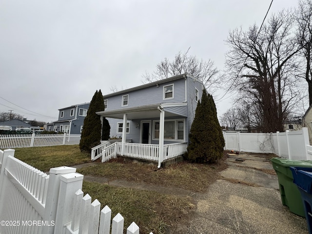 view of front of property with covered porch and a front yard