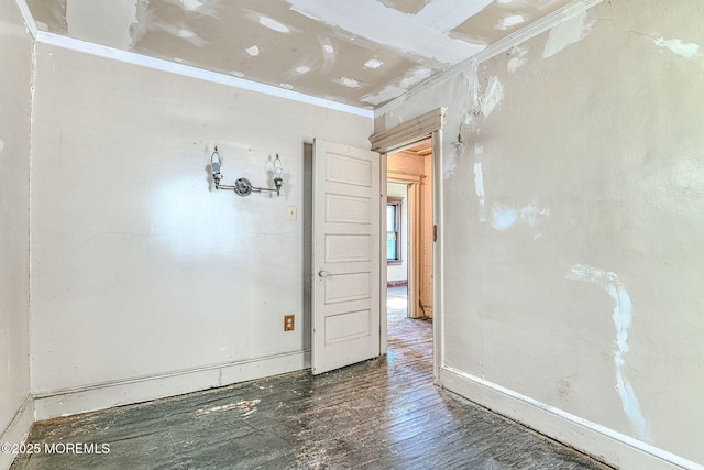 unfurnished room featuring ornamental molding and dark hardwood / wood-style floors