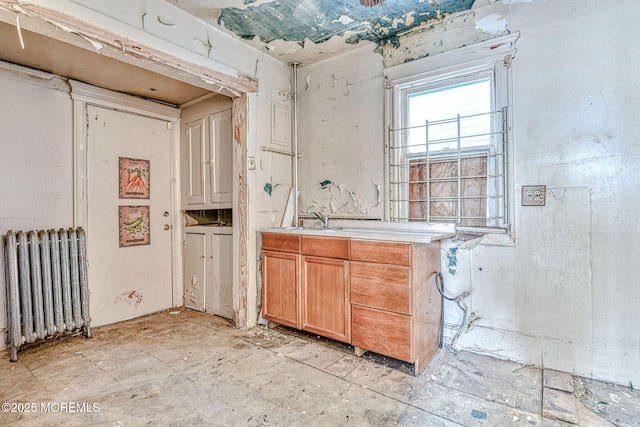 interior space featuring sink and radiator heating unit