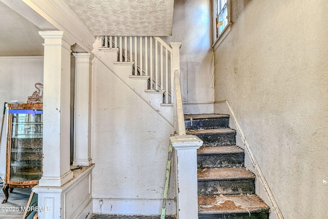 stairs with ornamental molding and decorative columns