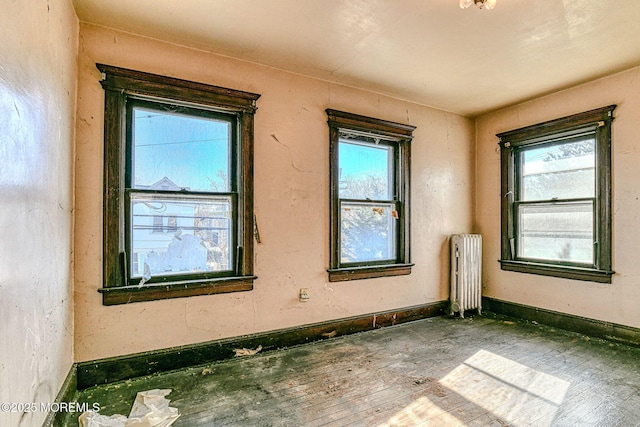 miscellaneous room with wood-type flooring and radiator