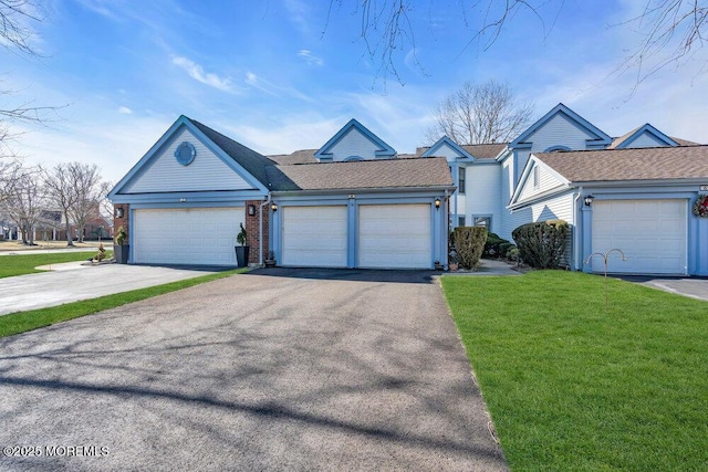 ranch-style house featuring a garage and a front yard