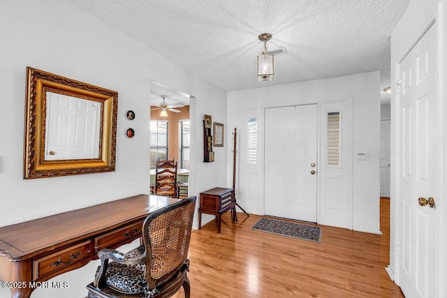 entryway featuring light hardwood / wood-style flooring and a textured ceiling