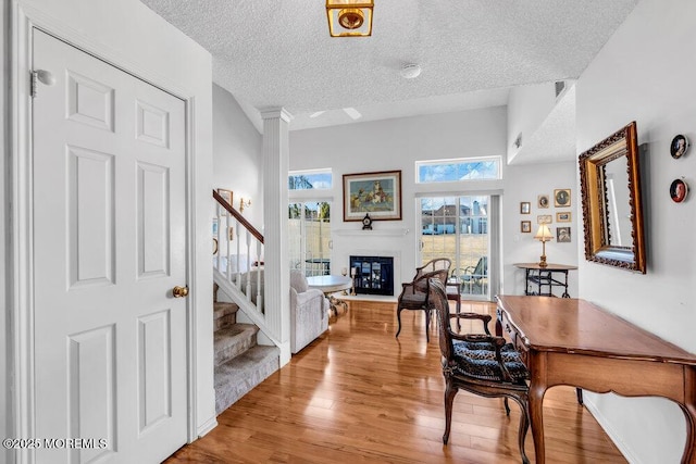 interior space featuring a textured ceiling and light hardwood / wood-style floors