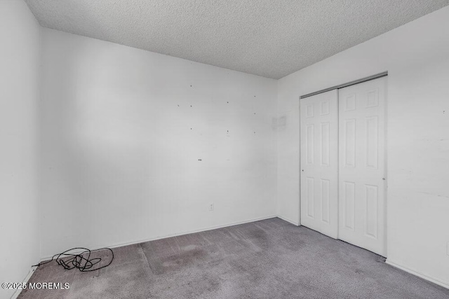 unfurnished bedroom featuring a closet, carpet, and a textured ceiling