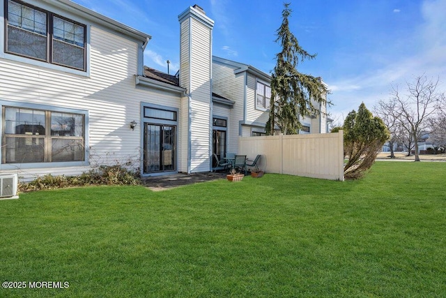 back of house featuring a lawn