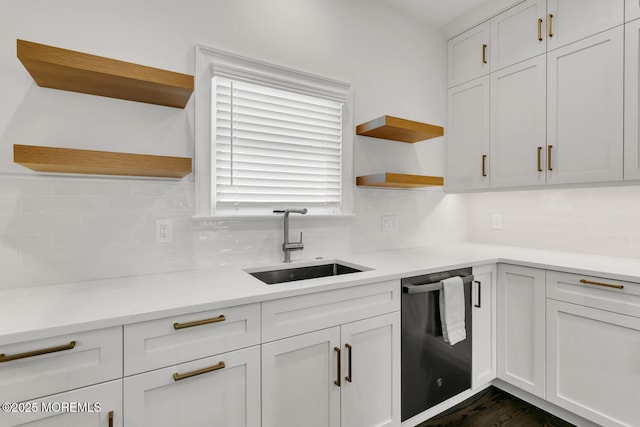 kitchen with dishwasher, white cabinetry, sink, and decorative backsplash