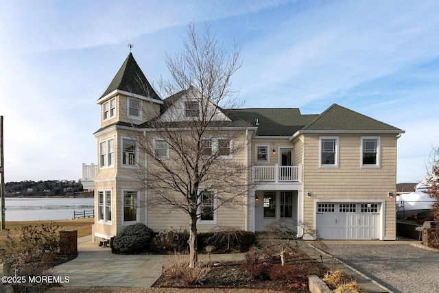 view of front of house with a garage and a balcony