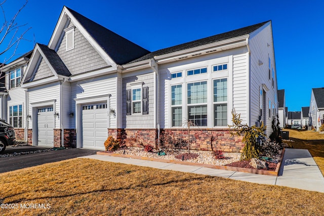 view of front of home with a garage and a front lawn