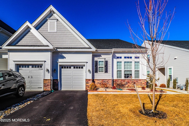 view of front of property with a garage and a front lawn