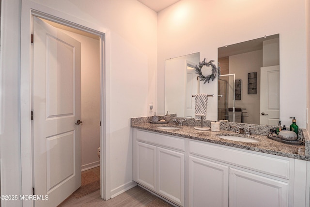 bathroom with vanity, wood-type flooring, toilet, and walk in shower