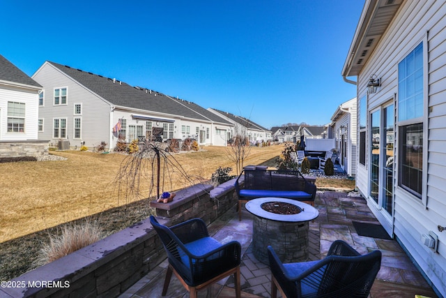 view of patio / terrace featuring central air condition unit and an outdoor fire pit