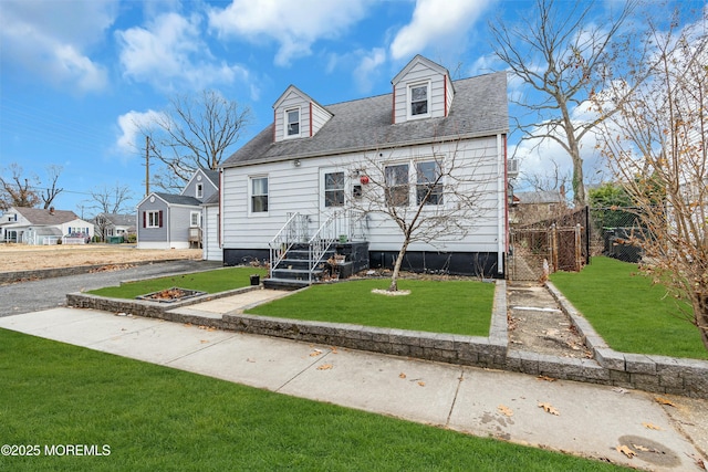 cape cod house featuring a front yard