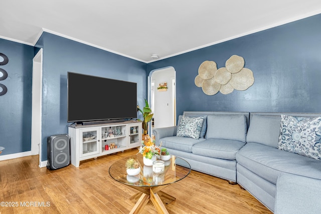 living room with crown molding and hardwood / wood-style floors